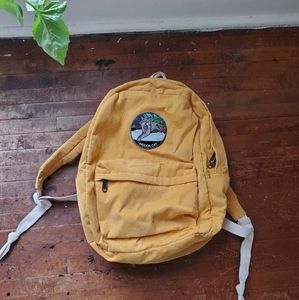 Yellow corduroy backpack indoor cat